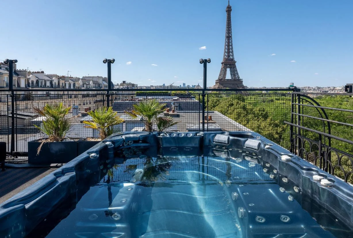 Rooftop jacuzzi and illuminated Eiffel Tower
