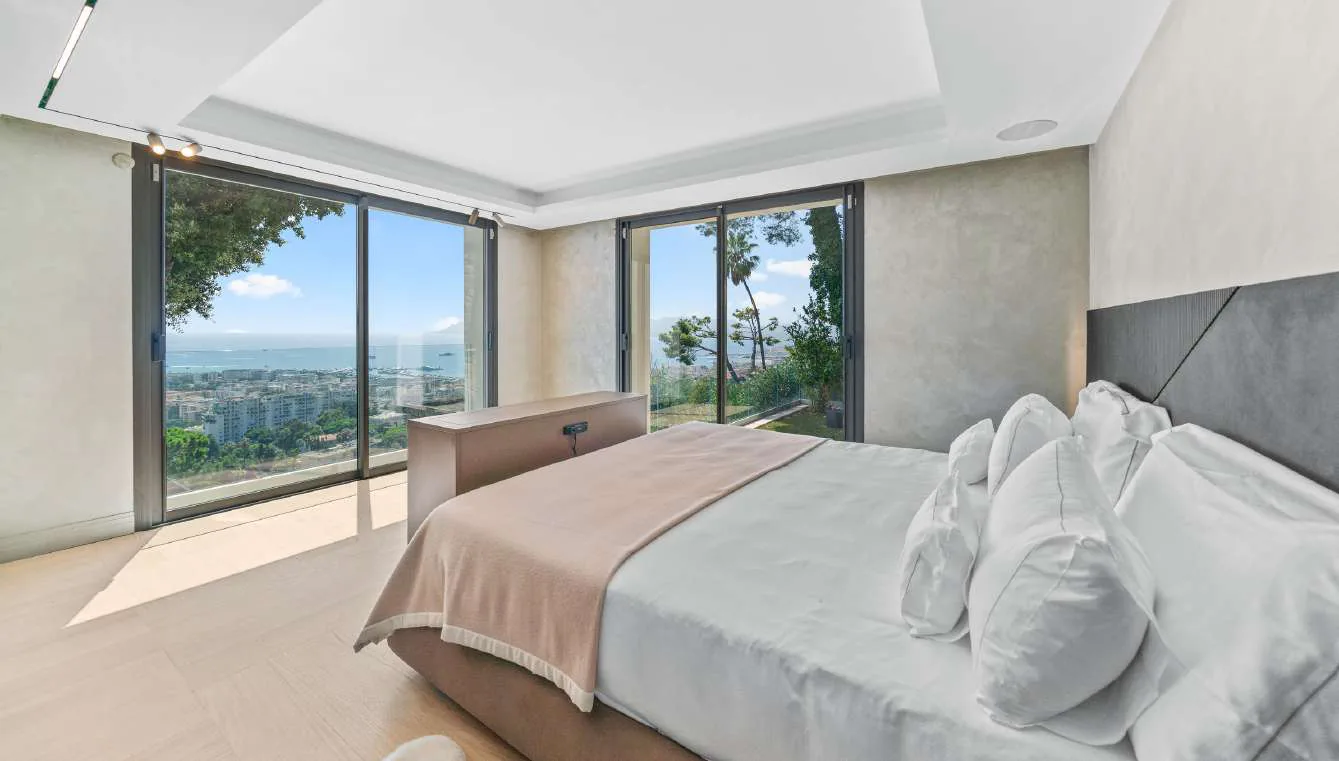 Chambre avec lit double, panneaux bois et vue mer panoramique