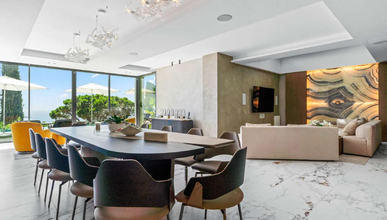 Salle à manger boisée avec suspension cristal et accès jardin