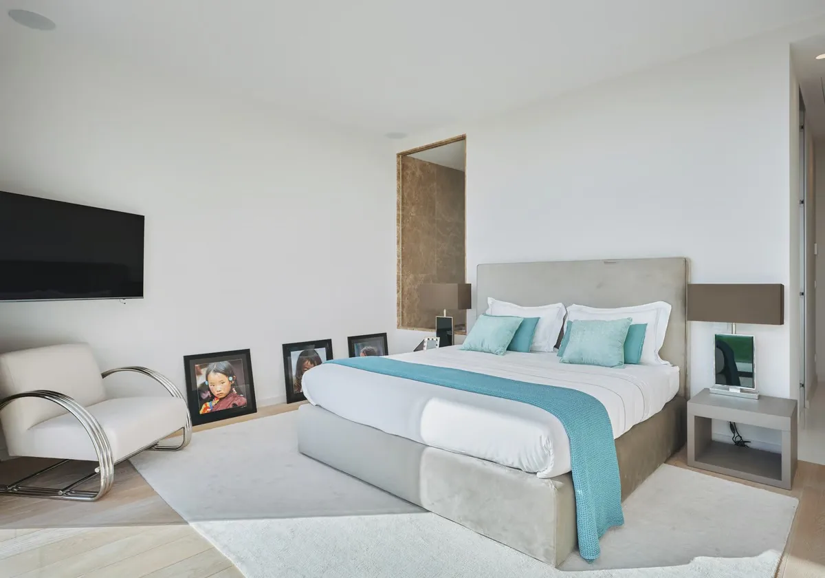 Chambre invités lumineuse avec cadres photo et linge turquoise
