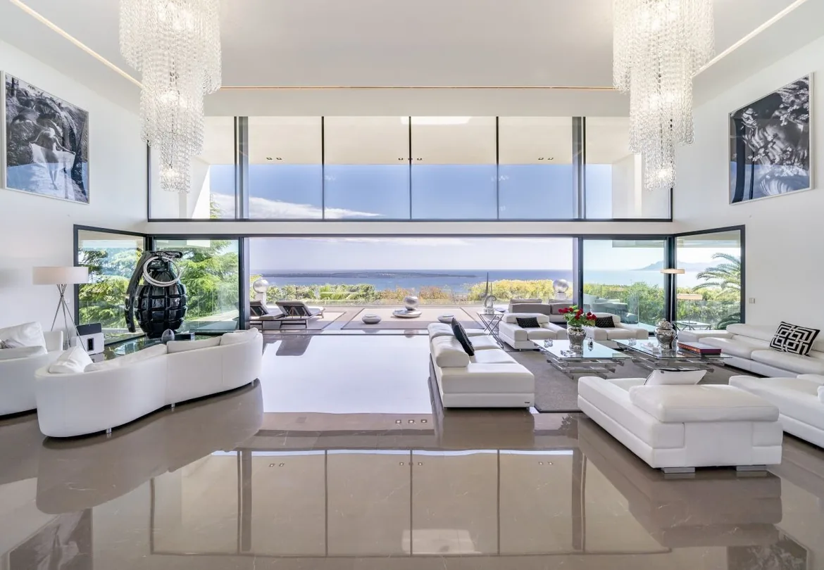 Salon double hauteur, lustres en cristal, vue mer